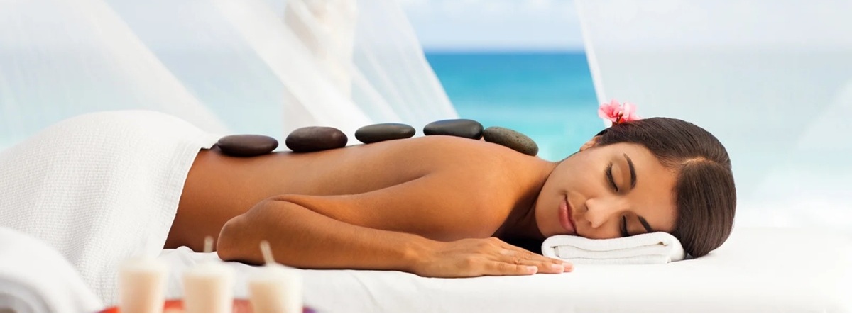 Woman on a massage table enjoying a hot stone massage