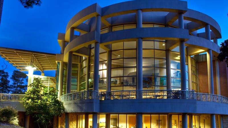 Night time view of windows and balcony at Mobile Museum of Art