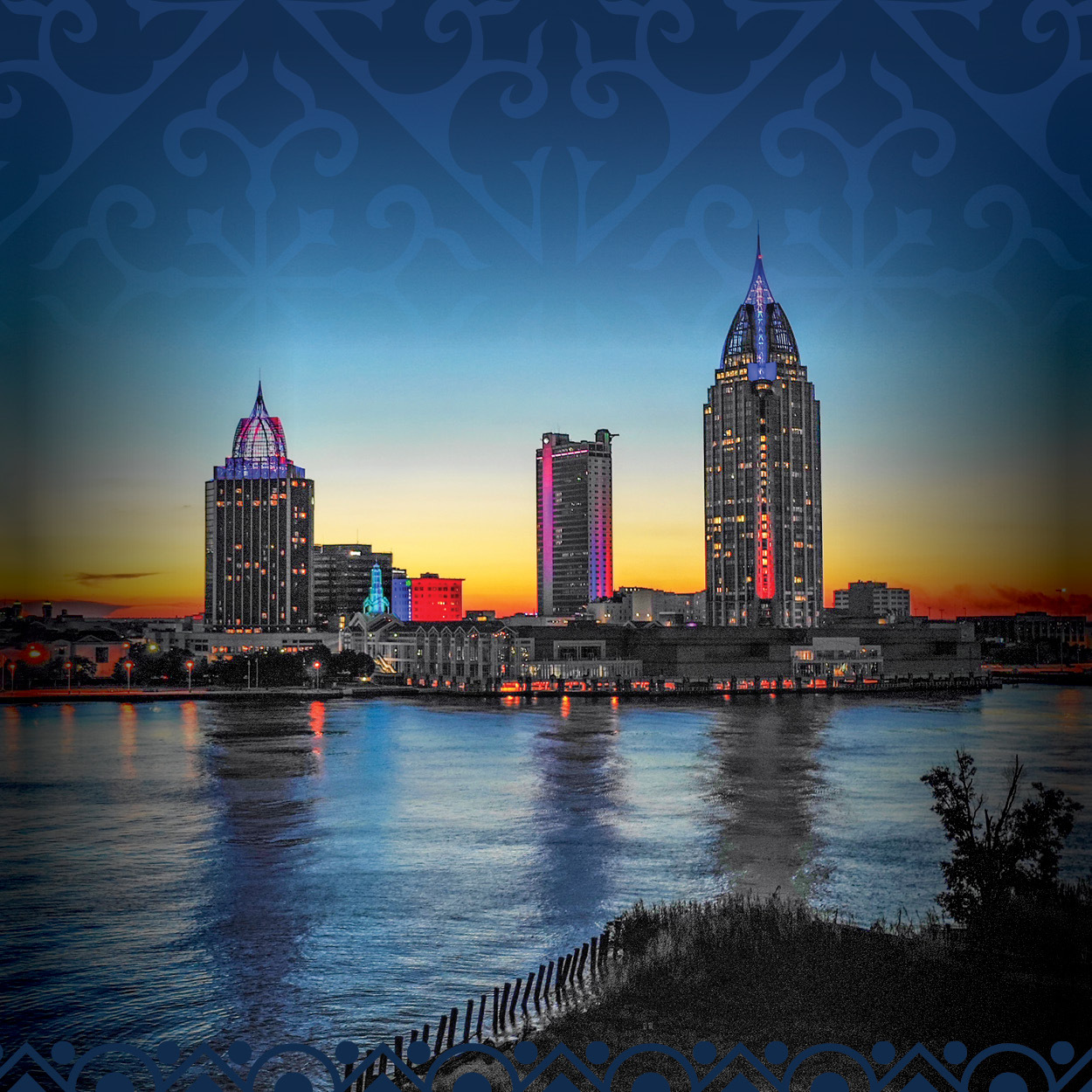 Sunset view of skyscrapers in downtown Mobile, Alabama taken from across the Mobile River